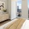 a bedroom with a bed and windows with a city view